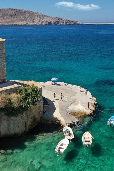 Aerial drone photo of beautiful fishing seaside village of Mezapos with crystal clear emerald beach in Mani Peninsula, Lakonia prefecture, Peloponnese, Greece